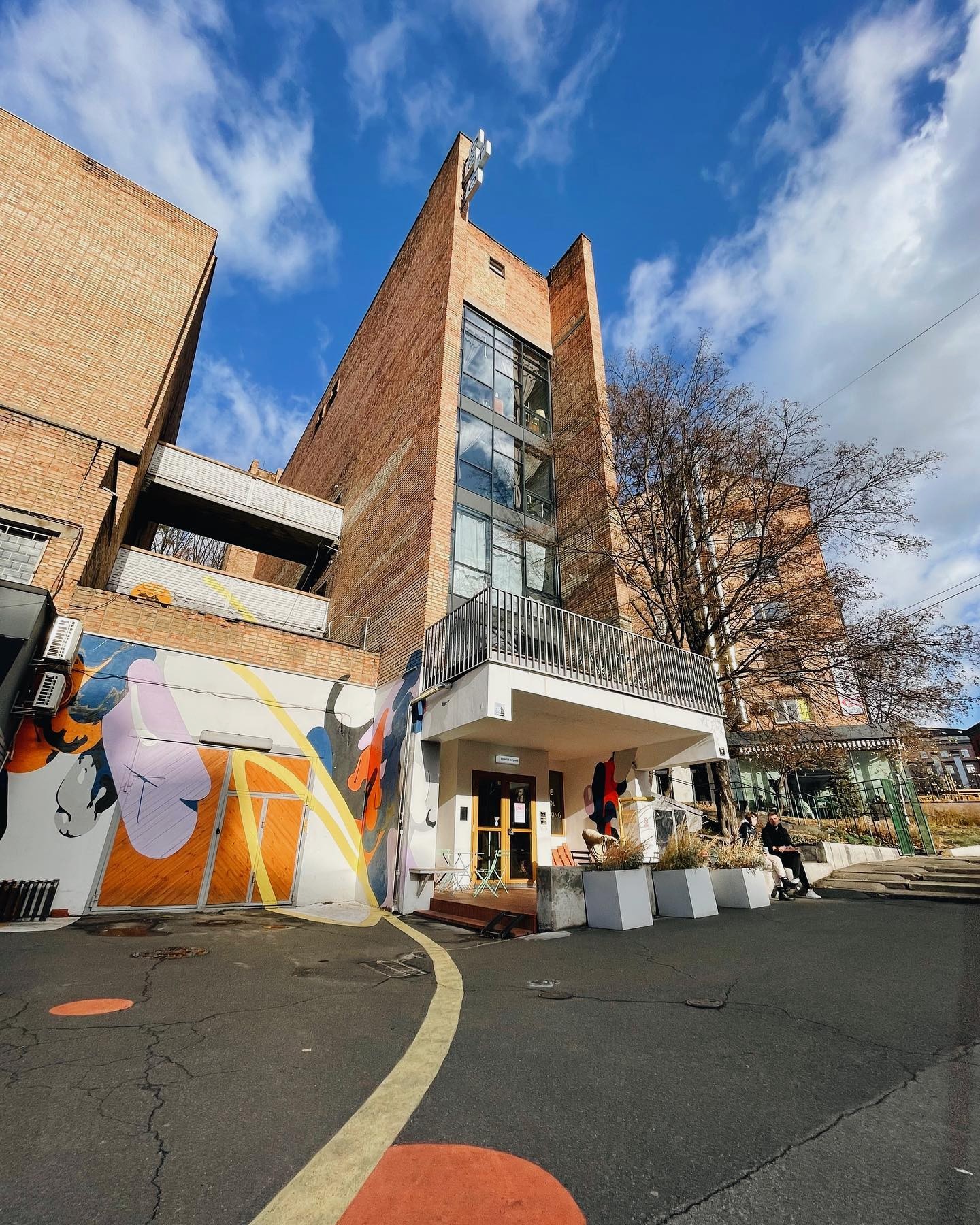 Octo Tower - brick building facade with colorful mural and entrance