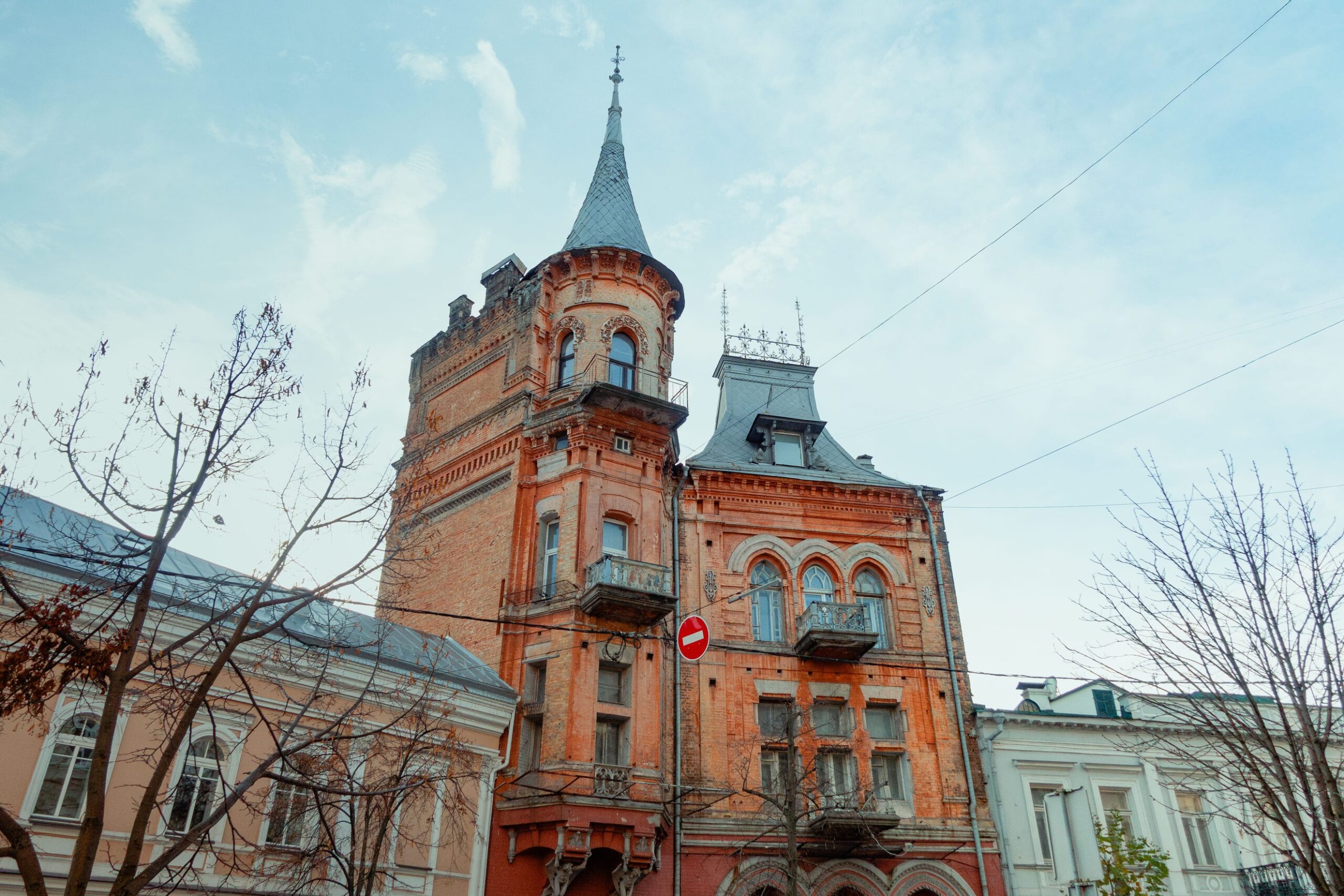 Barons castle in Kyiv - red brick Gothic facade with a high tower and arched windows
