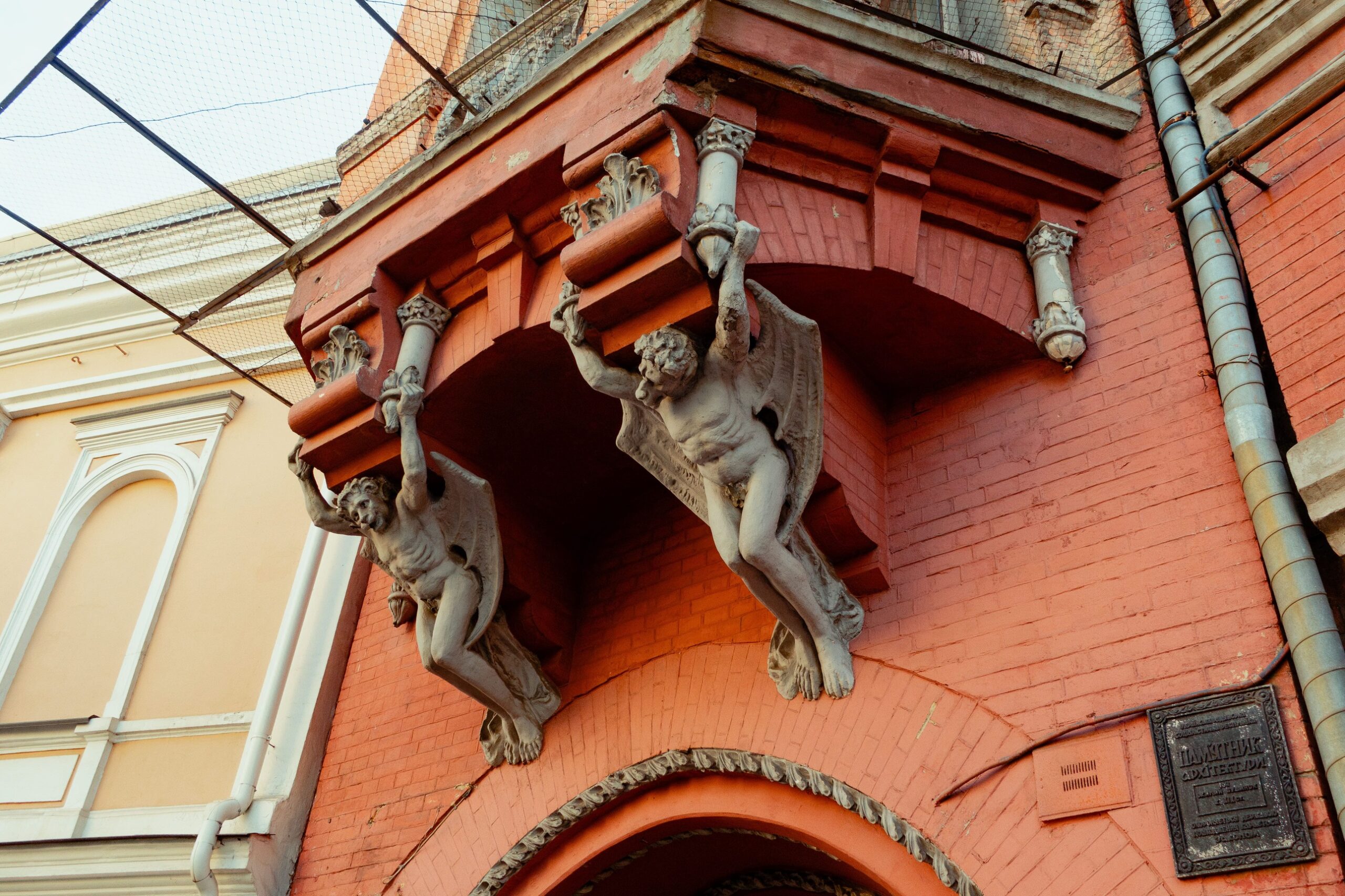 Barons castle in Kyiv - winged stone demons holding the balcony of the red castle