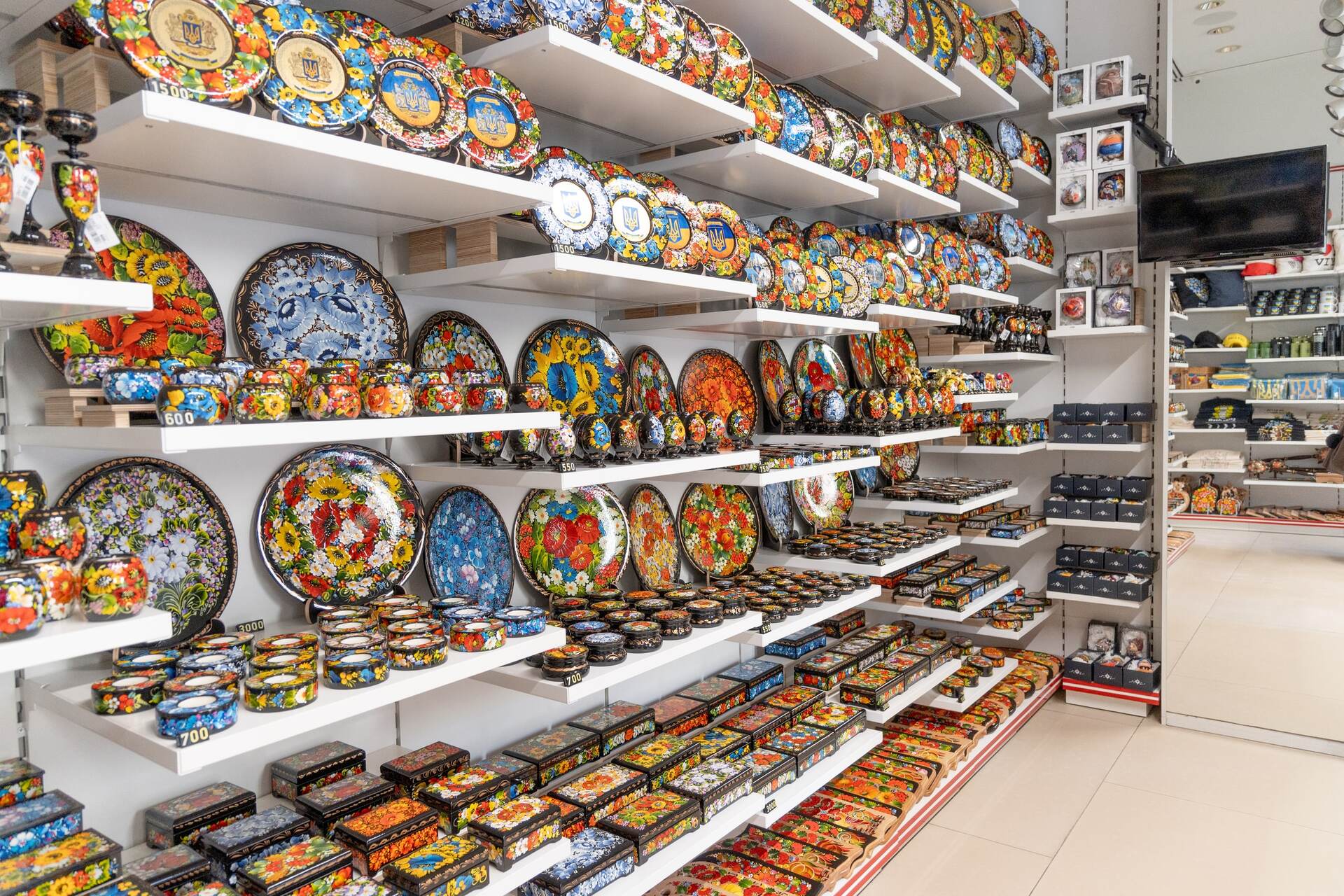 Rows of shelves filled with artfully hand-painted Ukrainian plates at the Folkmart store in Kyiv