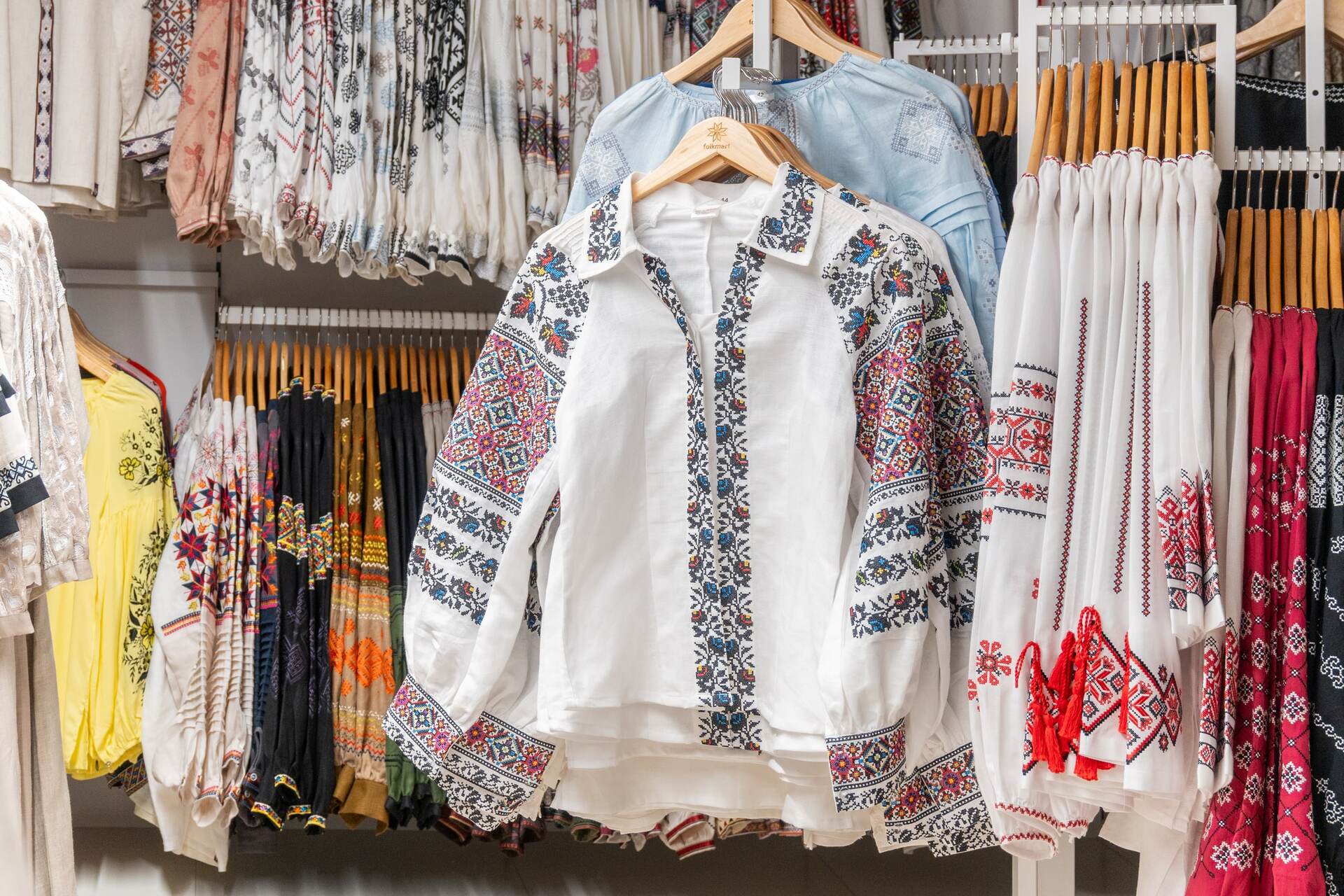 A close-up of vyshyvankas on hangers at Folkmart store in Kyiv