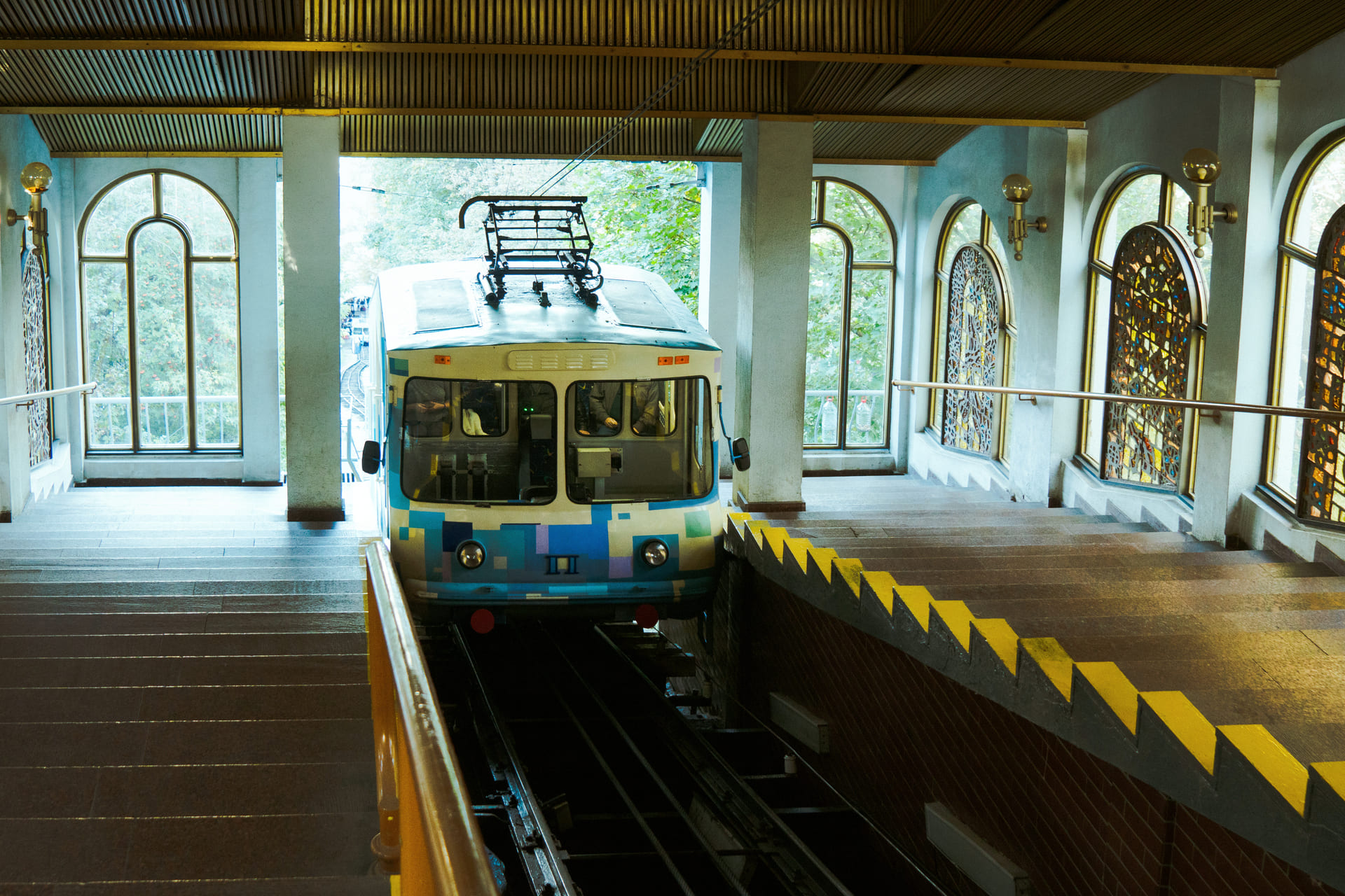 Kyiv Funicular photos - blue carriage at the station next to stained glass windows