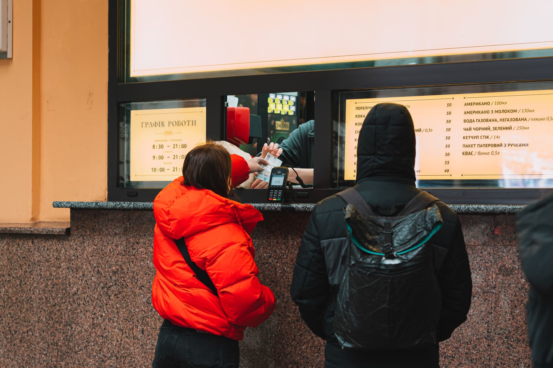 Customers ordering food at the Kyivska Perepichka street food window in Kyiv