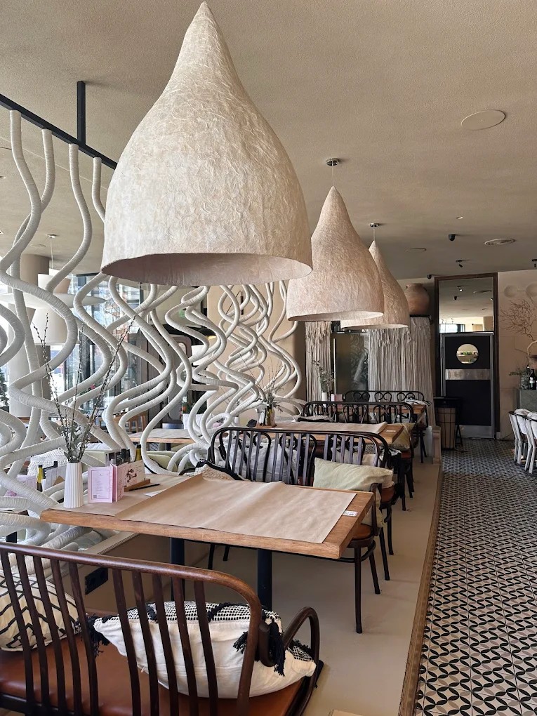 Mama Manana in Kyiv - interior with large decorative lamps above each table