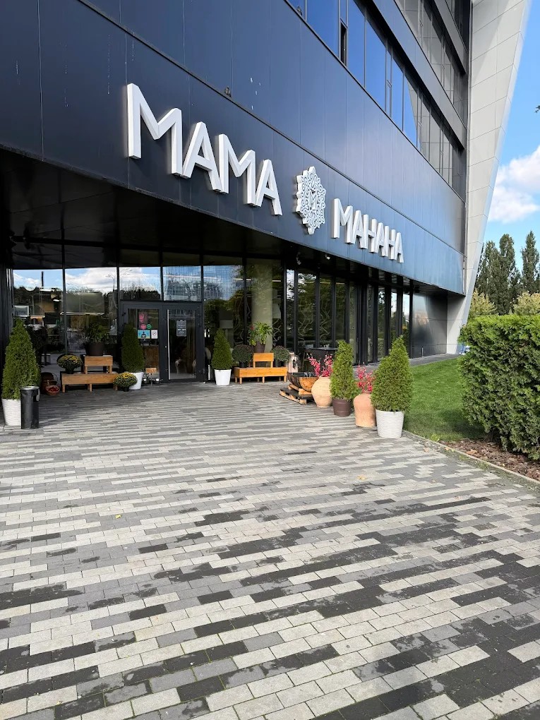 Mama Manana in Kyiv - modern glass entrance with a white logo