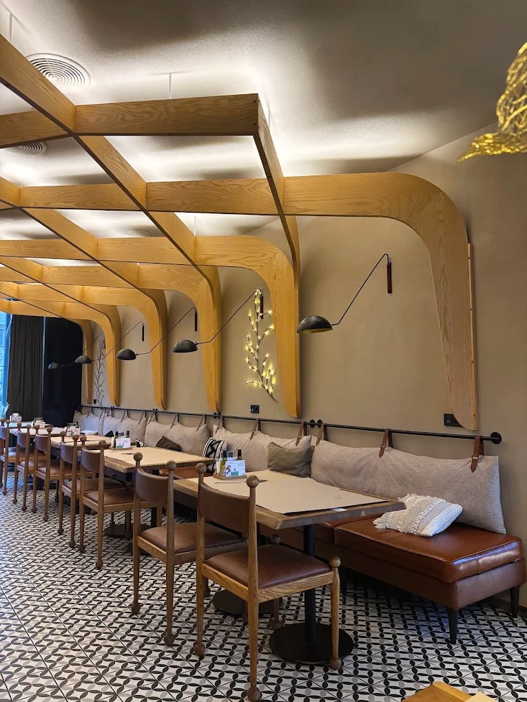 Mama Manana in Kyiv - cozy interior with sofas and a wooden decorative ceiling