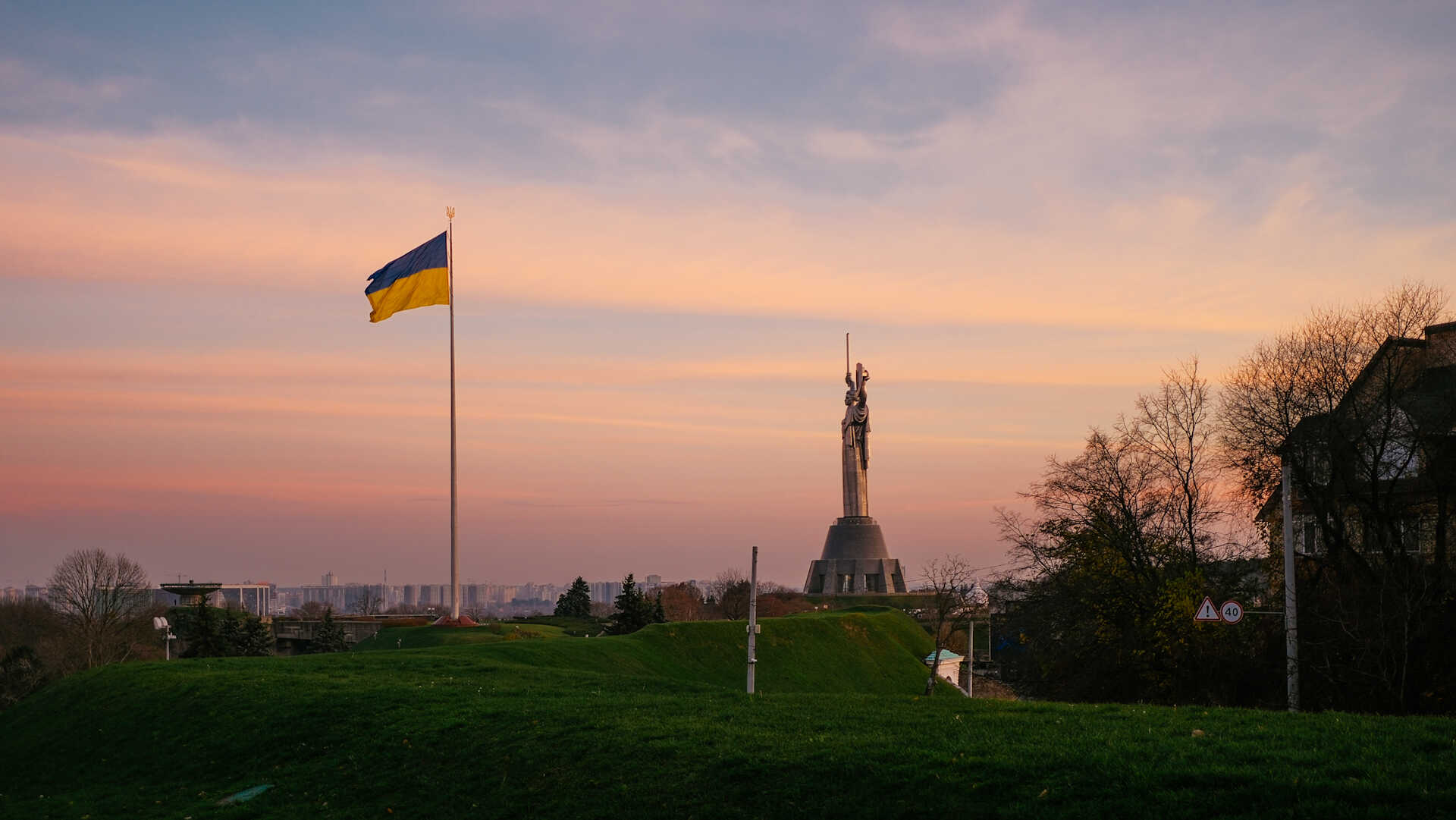 Panoramic view of flag and Motherland Monument at dusk