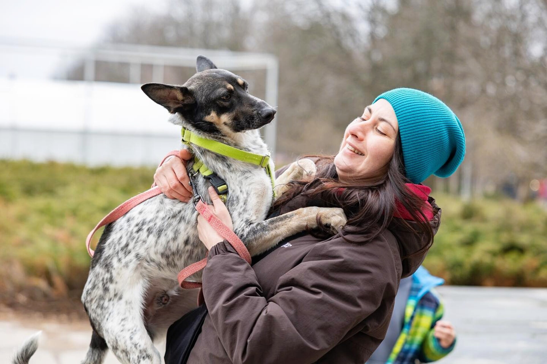 Patron Pet Center in Kyiv - smiling woman hugging a shelter dog