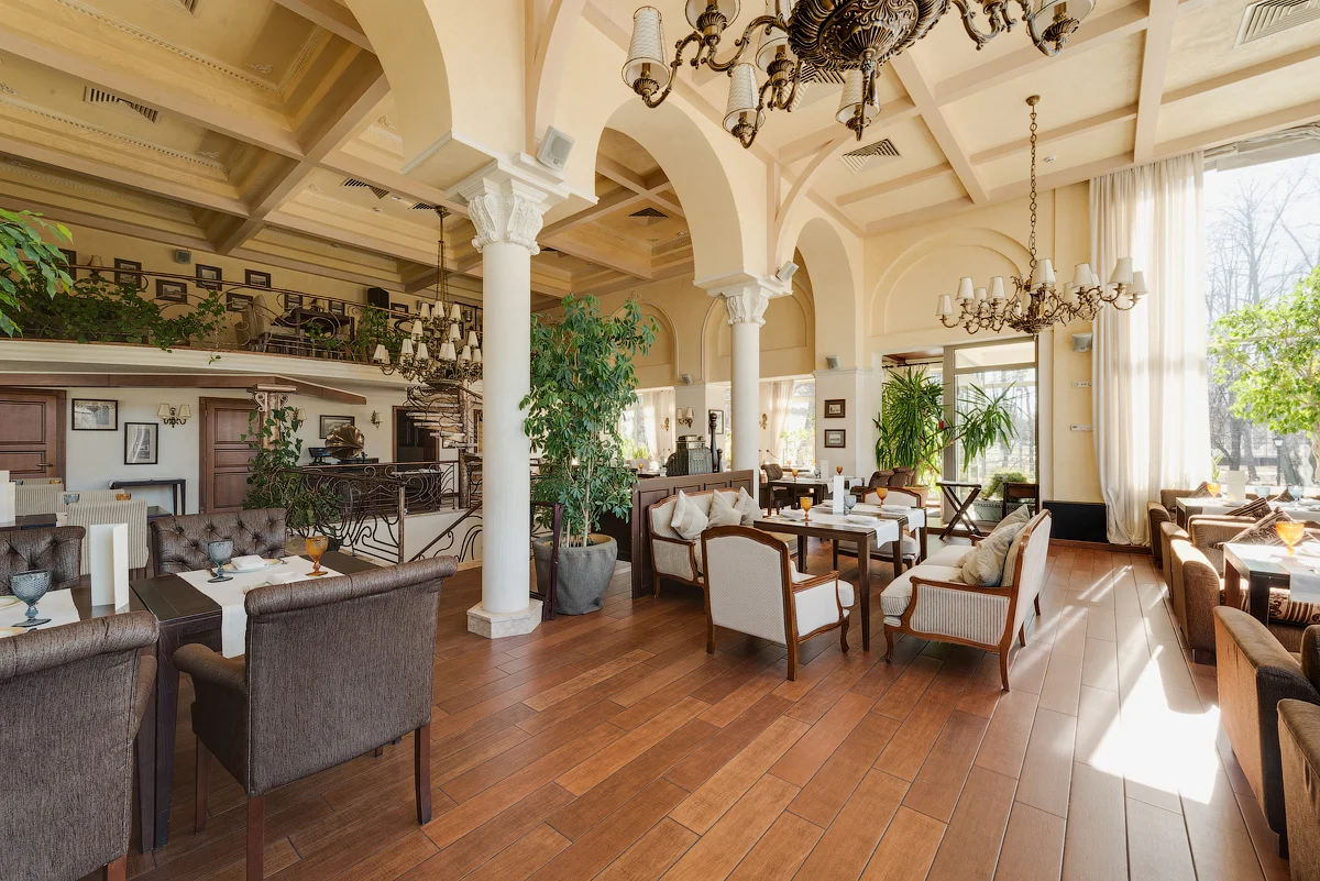 Praha restaurant in Kyiv - cozy interior with plants and a mezzanine