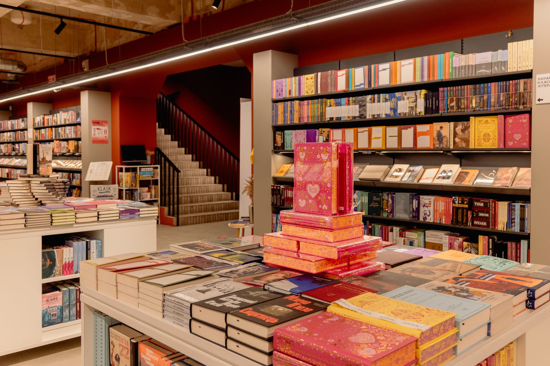 Main retail hall with book displays and stairs at Sens in Kyiv