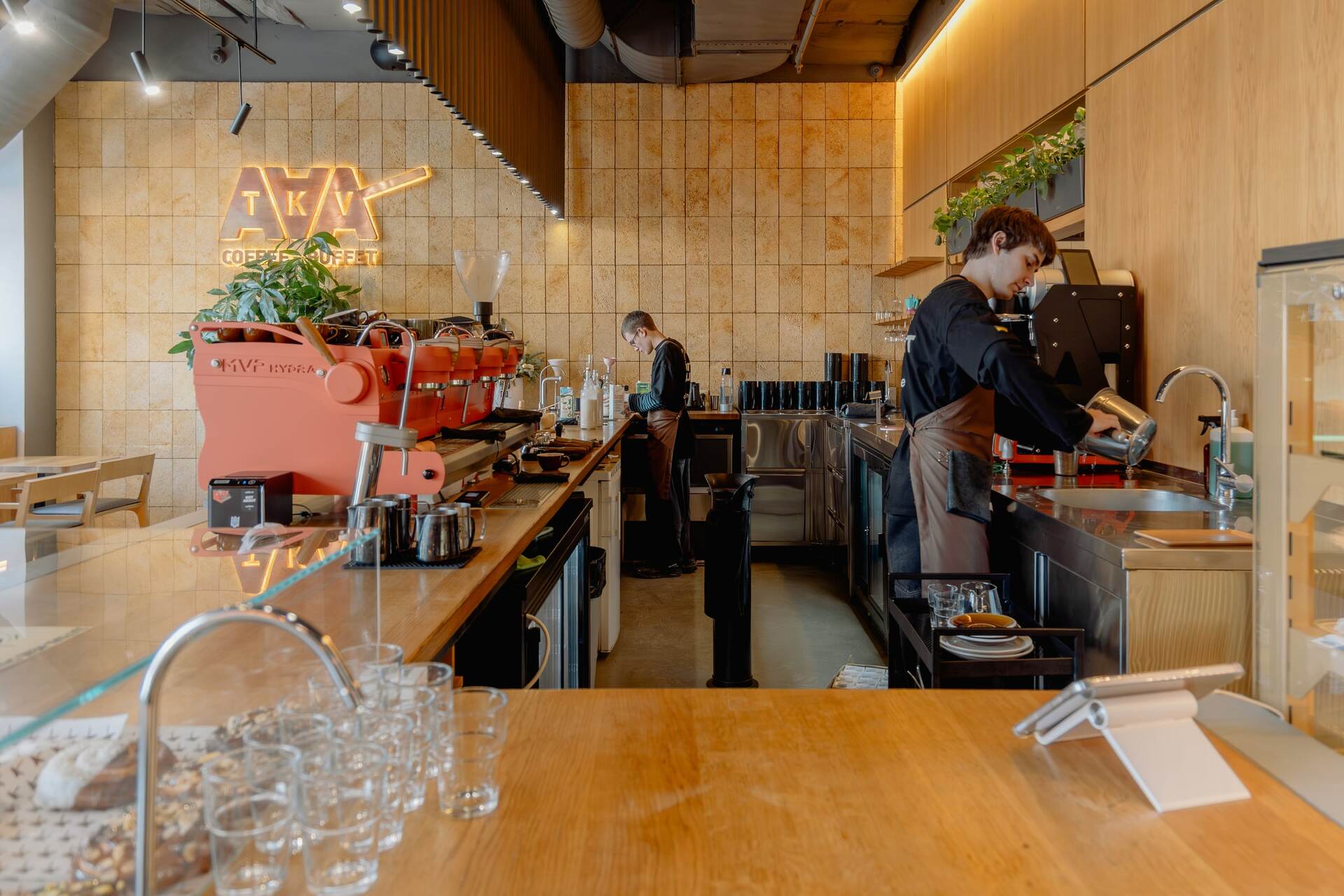 Bartenders working at the Takava coffee shop counter in Kyiv