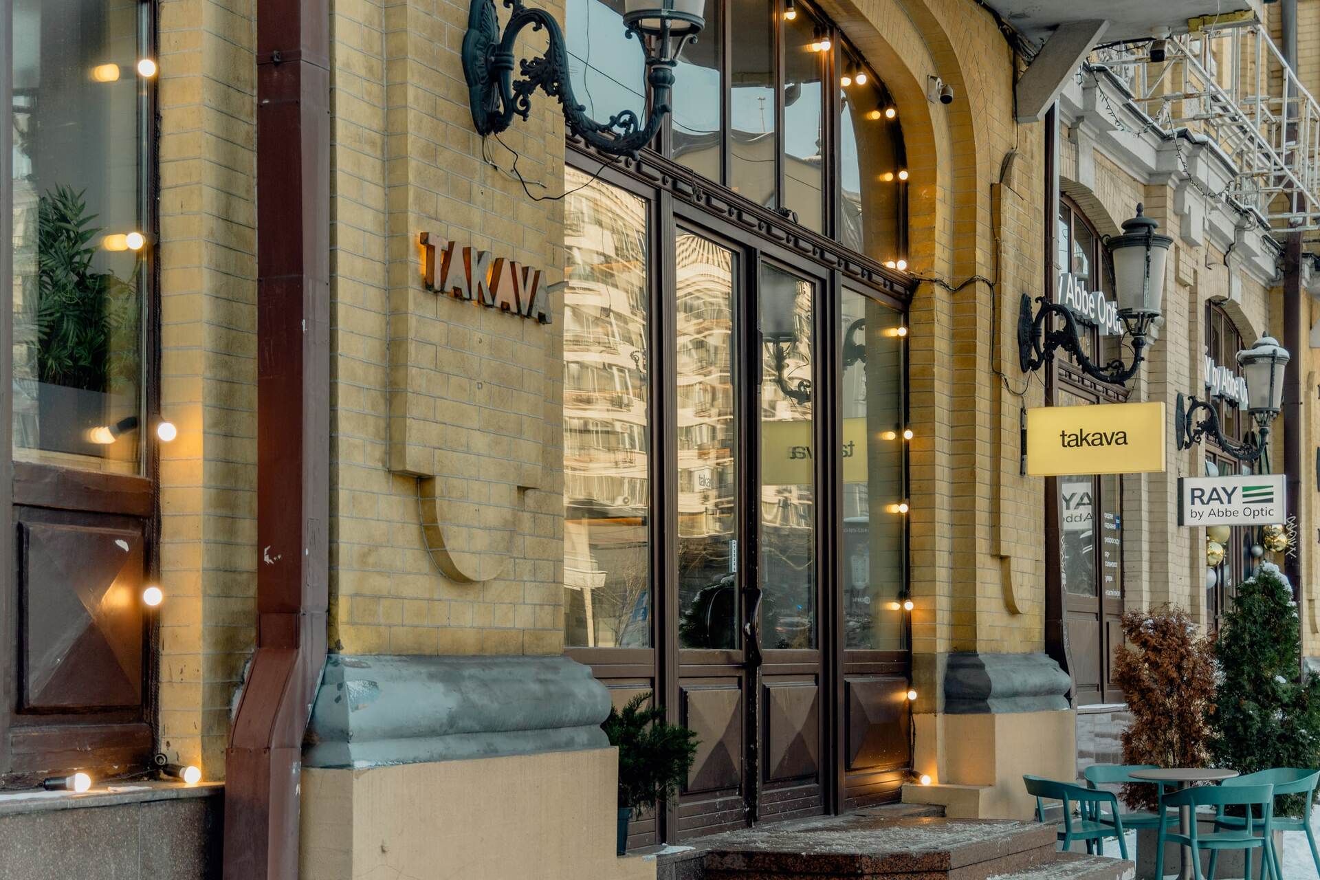 Exterior of Takava coffee shop entrance with bright signs in Kyiv