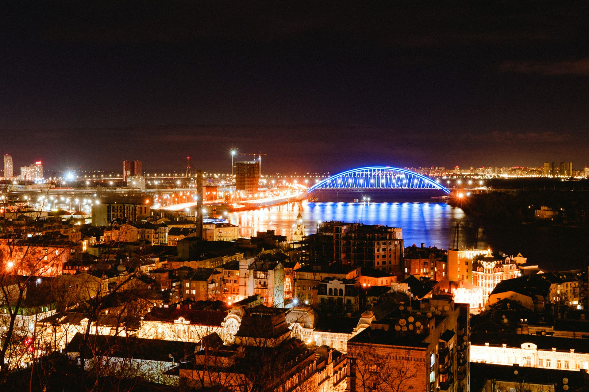 Night panorama of the Dnipro River and Podil from Volodymyrska Hill in Kyiv