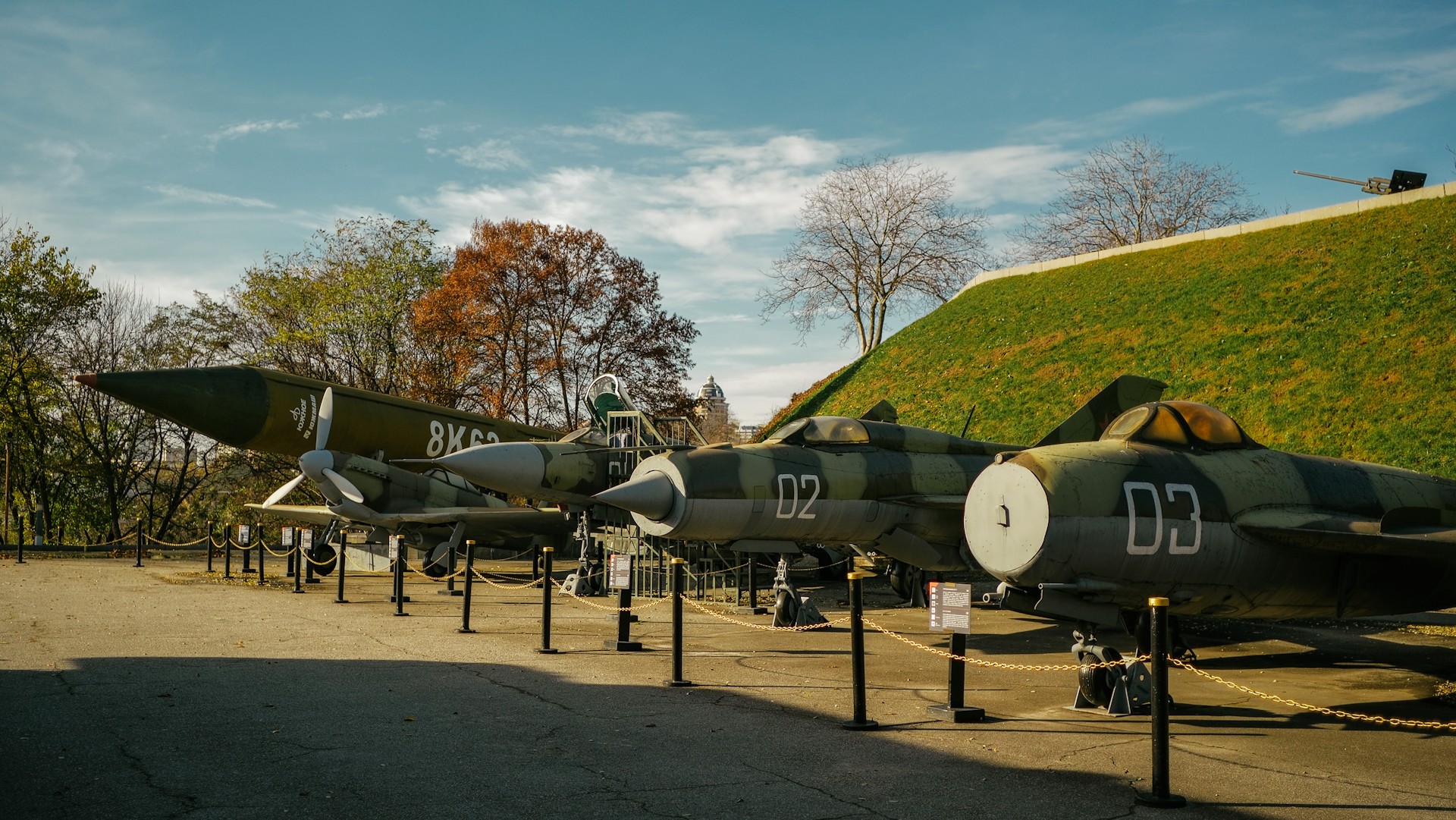 War Museum in Kyiv - row of vintage military fighter jets and a large ballistic missile