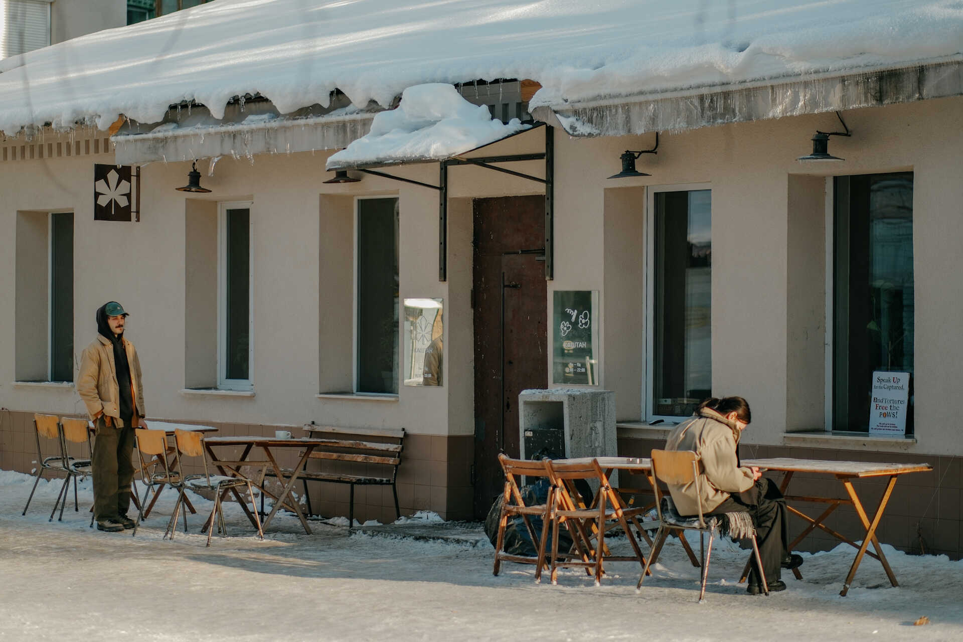 People at the snow-covered terrace of Kashtan Coffee in Kyiv