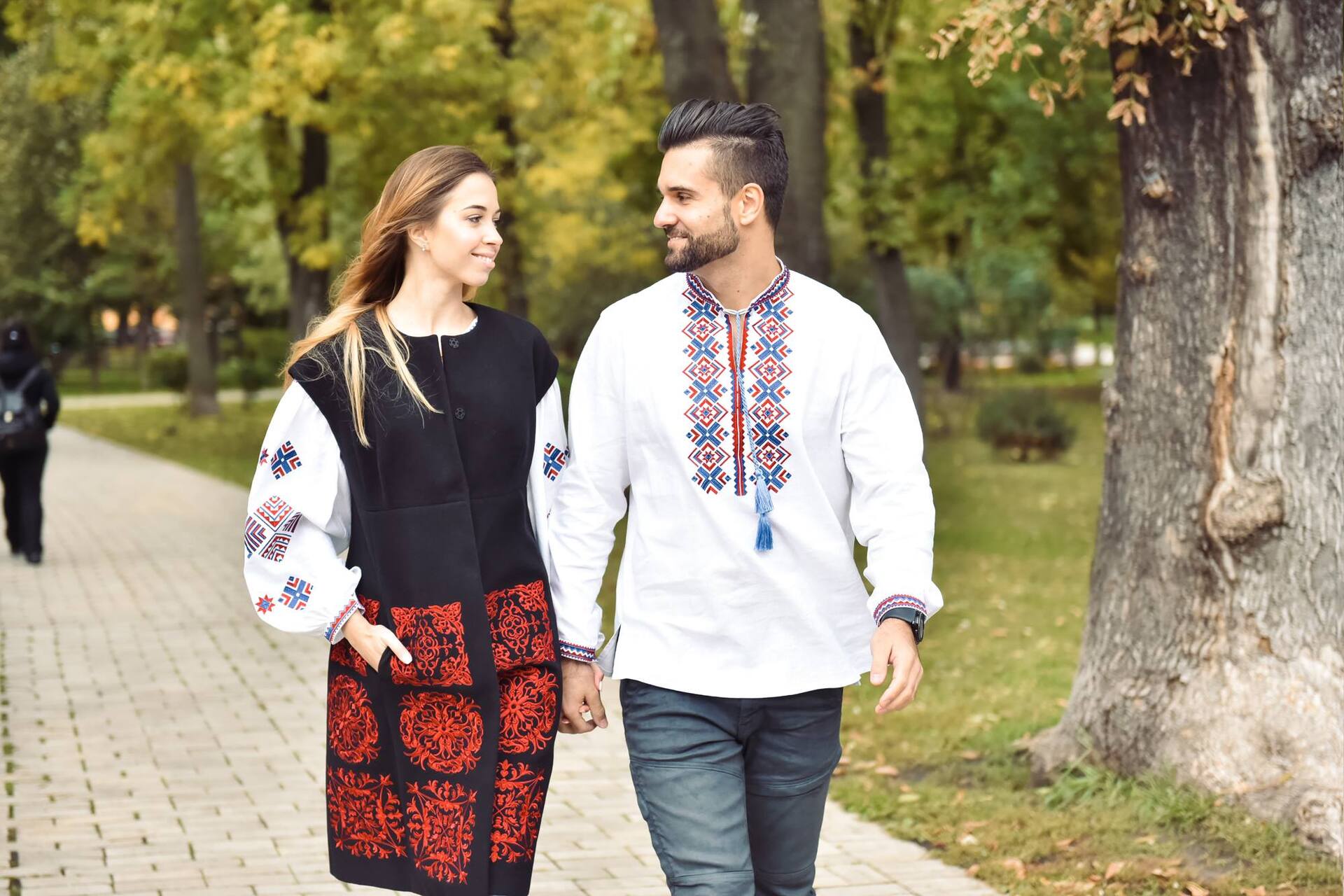 Couple wearing traditional Ukrainian vyshyvanka walking in a park in Kyiv