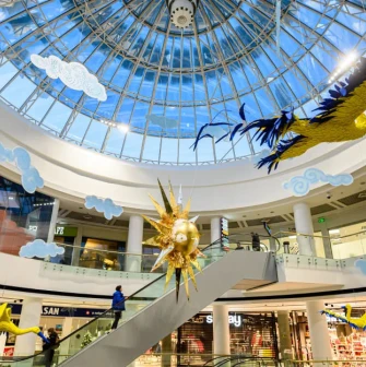 Interior of the Globus shopping center with a transparent dome and bright art installations