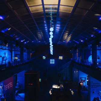 Science Museum at night with blue lighting and installations