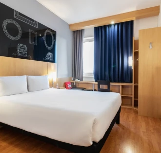 Ibis Railway Station in Kyiv - bedroom with white bed and black chalkboard wall