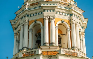 Kyiv Pechersk Lavra - the Great Lavra Bell Tower with white columns and a visible bell inside