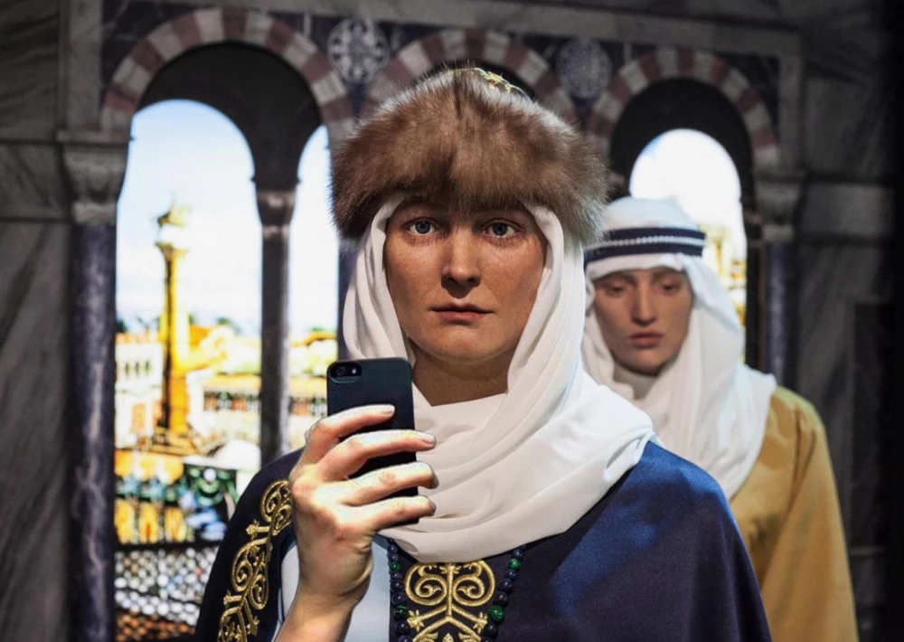 Muzei Stanovlennia Ukrainskoi Natsii in Kyiv - close-up of a realistic wax figure in medieval Kyivan Rus headwear holding a modern smartphone