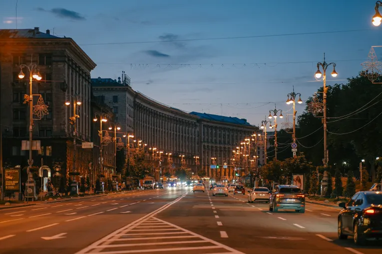 Khreshchatyk Street, Kyiv’s main street, in the evening, lit by streetlights and car headlights.