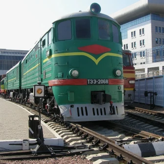 Railway Museum in Kyiv - massive green vintage diesel locomotive standing proudly on the tracks under the bright sun at the open-air museum