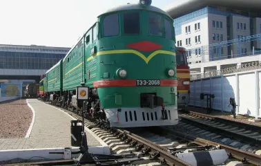 Railway Museum in Kyiv - massive green vintage diesel locomotive standing proudly on the tracks under the bright sun at the open-air museum
