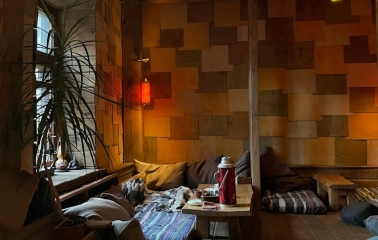 Chaguan in Kyiv - low seating area with floor cushions and hanging red lanterns