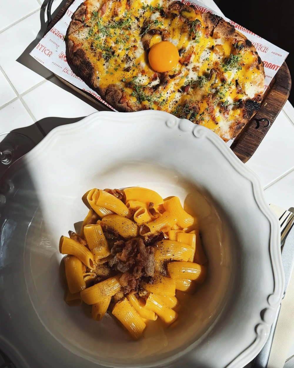 Pizza and pasta with bacon at Romantica