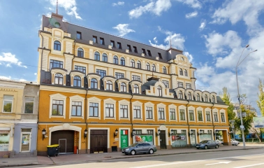 Verkhnii Val in Kyiv - bright orange building with a mansard roof
