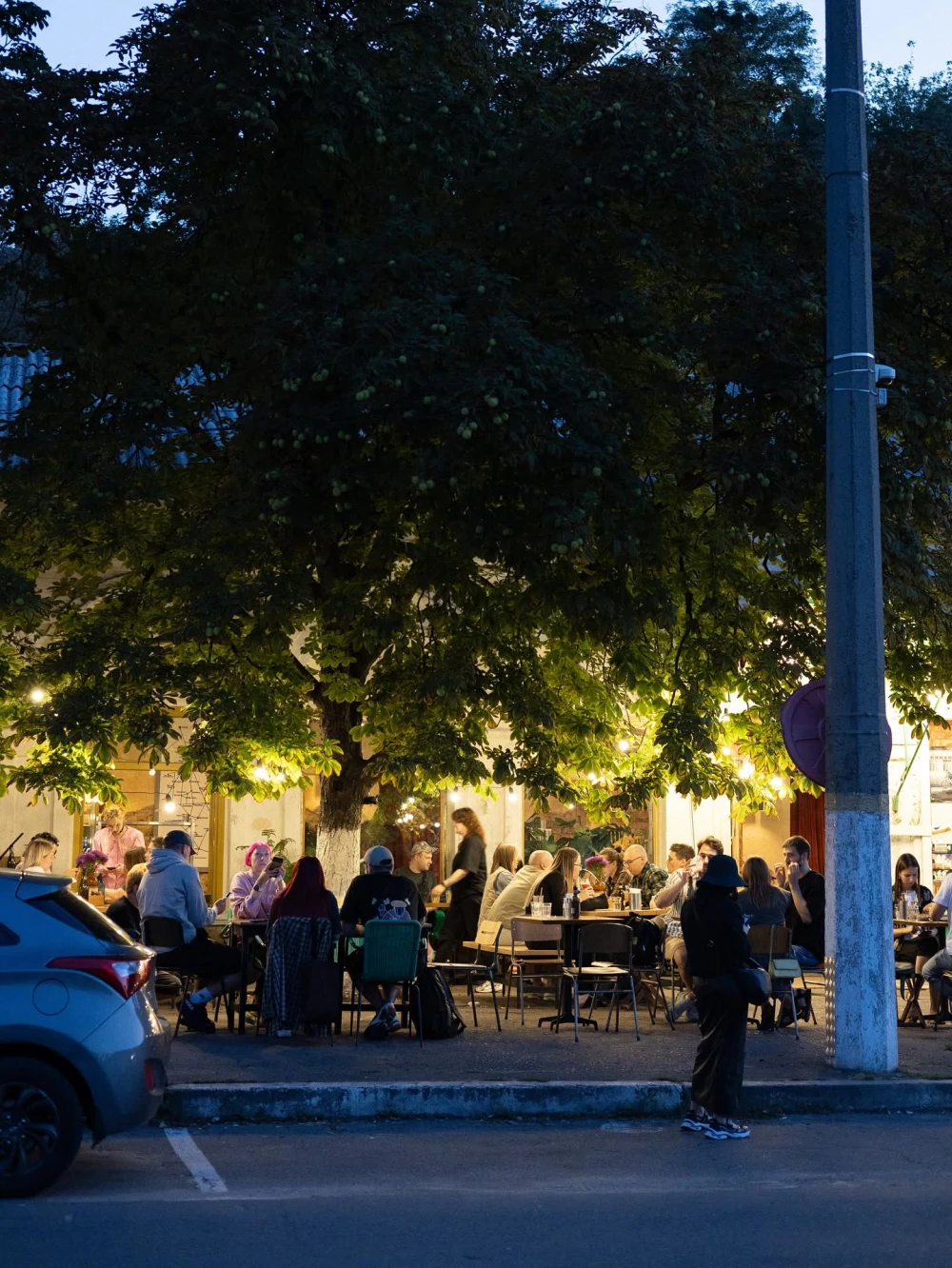 Autostation pizzeria summer terrace in the evening near a tree