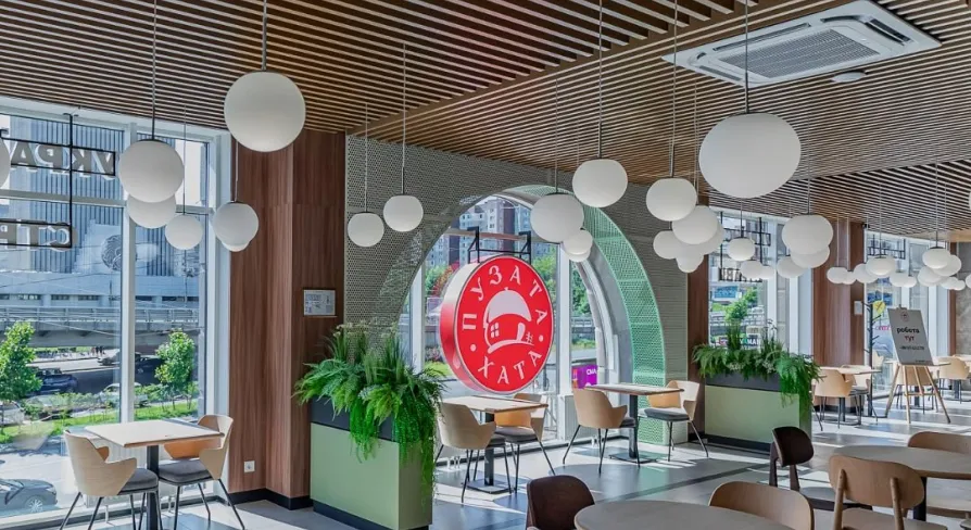 Restaurant Puzata Hata - bright dining area with large windows and the red Puzata Hata logo