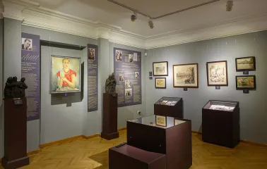 Muzei Ukrainskoi Diaspory in Kyiv - detailed view of the exhibition featuring a vibrant portrait of a woman and bronze sculptures in a well-lit gallery space