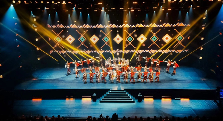 Palats Ukraina in Kyiv - vibrant stage performance by a folk dance ensemble in red costumes