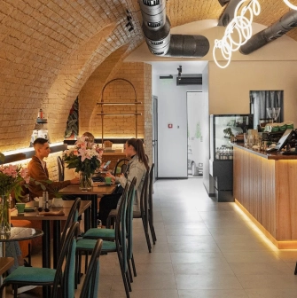 Idealist Coffee - dining area with small wooden tables