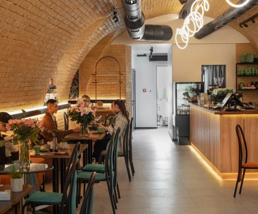 Idealist Coffee - dining area with small wooden tables