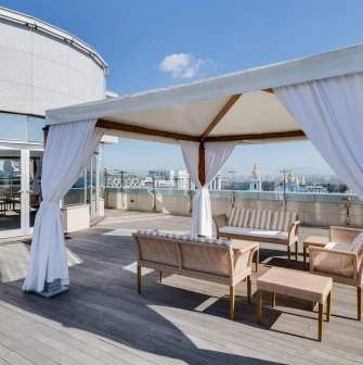 Hyatt Regency - rooftop terrace with elegant outdoor seating and city view