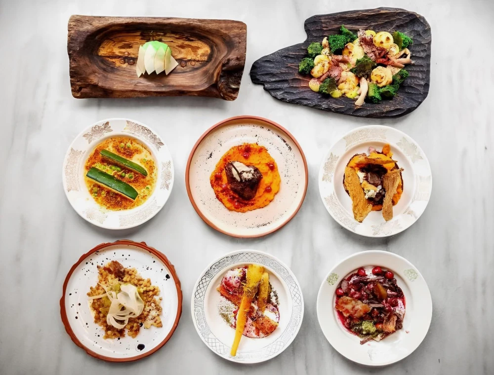 Restaurant 100 Rokiv Tomu Vpered - overhead view of a eight-course set menu on a marble table