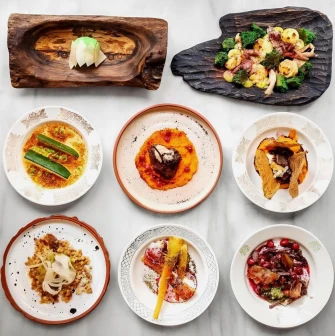 Restaurant 100 Rokiv Tomu Vpered - overhead view of a eight-course set menu on a marble table