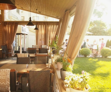 Restaurant Very Well Cafe - outdoor dining terrace featuring modern tables chairs and decorative plants