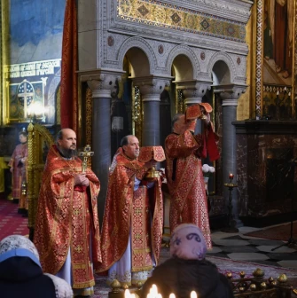 St. Volodymyr's Cathedral in Kyiv - priests in red robes lifting golden chalices at altar