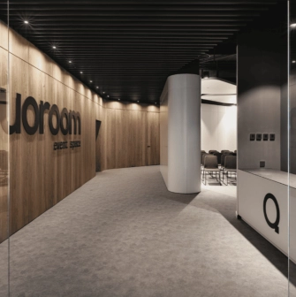 IQ Business Center in Kyiv - hallway featuring wooden wall with Quoroom event space logo