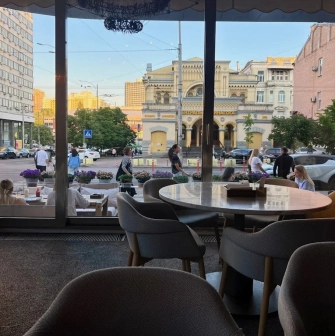 Bright modern hall of the Holy Burger restaurant in Kyiv with wooden tables