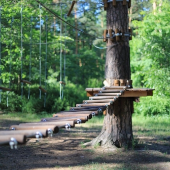Seiklar Park in Kyiv - wooden suspension bridge with logs swinging in the air