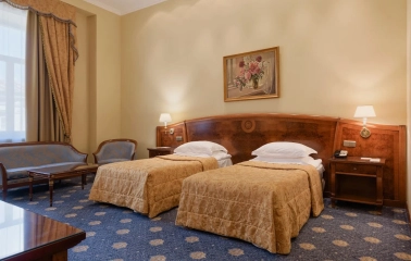 Classic room at Premier Palace Hotel in Kyiv with two beds and a seating area