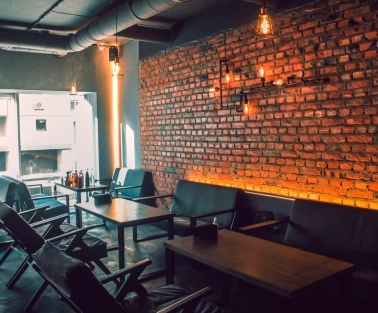 Vugol na Arsenalnii - lounge area with brick wall and sofas