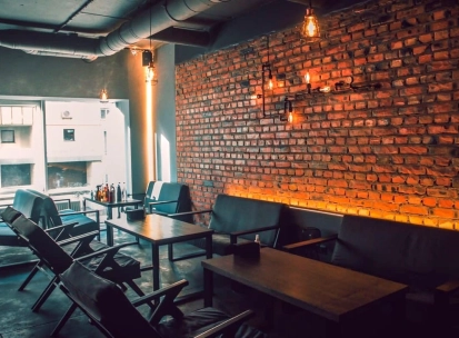 Vugol na Arsenalnii - lounge area with brick wall and sofas