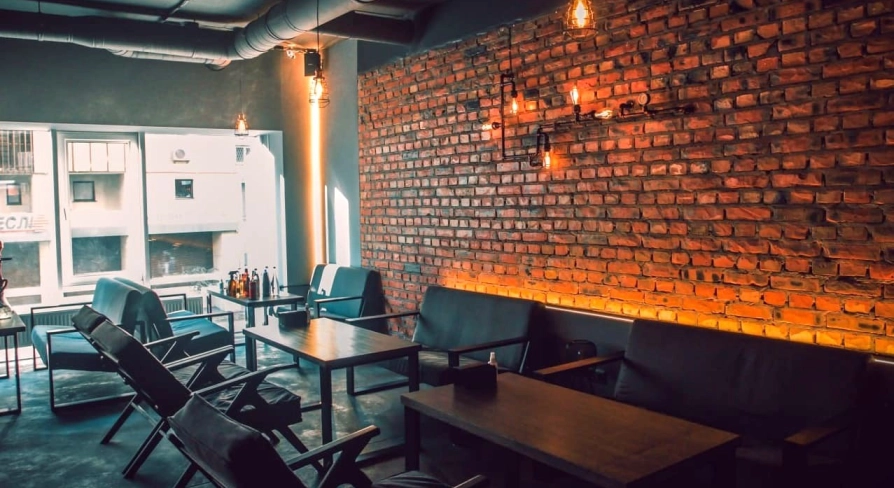 Vugol na Arsenalnii - lounge area with brick wall and sofas