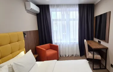 Hotel room at Bontiak Hotel with a desk and armchair